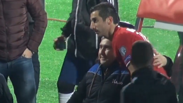Mkhitaryan presents his shirt to a fan in wheelchair