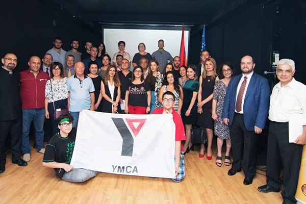 YMCA members and volunteers in Armenia with Armenian Assembly of America Regional Director Arpi Vartanian (third from right), Armenian Minister of Education Arayik Harutyunyan (second from right), and YMCA Armenia Acting Director Khoren Papoyan (far right) at the ANI Exhibit Opening in Yerevan