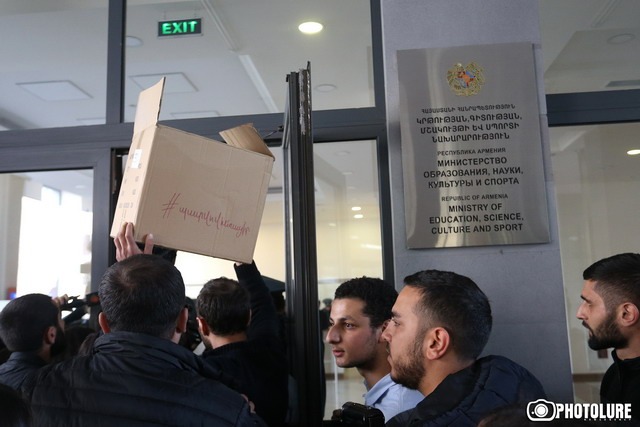 Young members of the Armenian Revolutionary Federation bring boxes for the minister to gather his belongings and leave