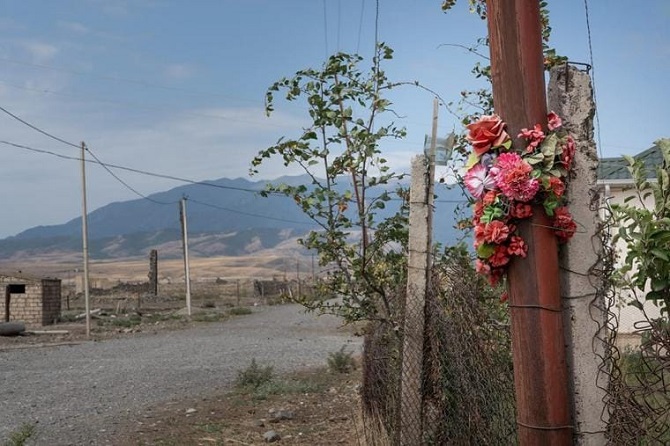 Flowers have been placed here, 100m from the Line of Contact, in memory of a girl shot dead during the 2016 escalation in Hasanqaya, a village located in Azerbaijan's Tartar region. CRISISGROUP/Jorge Gutierrez Lucena