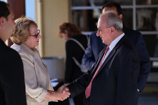 Dr. Adalian greeting Jane Stanton and Lionnel Zaragoza, representing the YMCA of Metropolitan Los Angeles