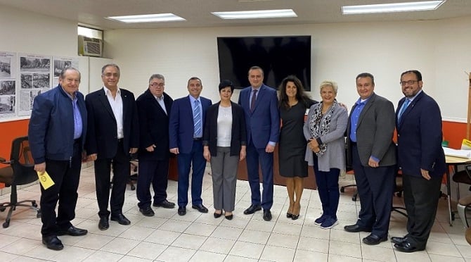 YMCA of Glendale Board Members and staff with Republic of Artsakh Minister of Education, Science and Sport Narine Aghabalyan, Artsakh’s Permanent Representative in Washington, DC Robert Avetisyan, and Assembly Western Region Director Mihran Toumajan. The ANI exhibition is on display in the background.