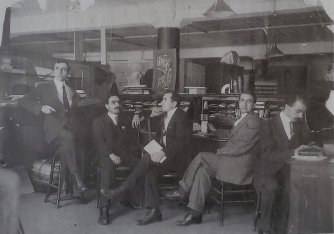 Hairenik staff, spring 1911, at the 7 Bennet Street, Boston location. Haroutioun Hovanes Chakmakjian (Hairenik editor 1909-1911) is seen working (far right), with Siamanto (Hairenik editor 1909-1911) seated behind him. A professor of chemistry at Tufts University, Chakmakjian wrote numerous books in several languages. His notable publications included an English-Armenian dictionary—an enduring work of Armenian lexicography, which remains regularly used today—as well as a 700-page history of Armenia. He was also the father of famed American composer Alan Hovhaness. Poet Siamanto (born Atom Yarjanian) is considered one of the most influential Armenian writers of the late 19th century and early 20th century. He was killed by the Ottoman authorities in 1915 during the Armenian Genocide.