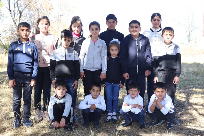 Students from the neighboring Kruglaya Shisha village who would have to walk five kilometers one way to get to school in Medovka.