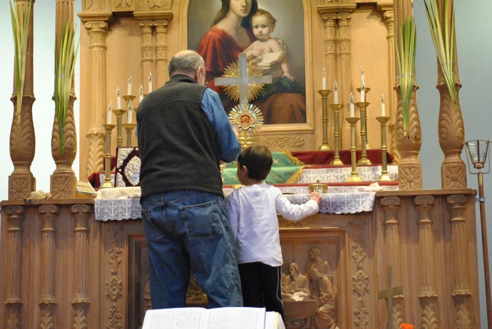 At four years old, Avedis Bell was helping prepare the altar for Palm Sunday during church clean up day (2013).