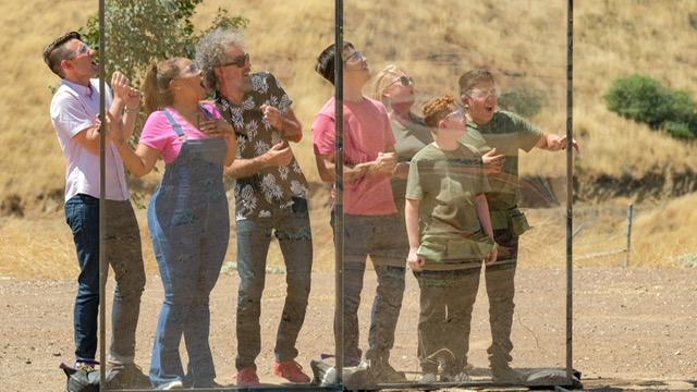 Watching a launch behind a protective barrier: from left, the 3 judges, the host Justin Long, and Daron’s team (Daron, Marco and Coach Kim)