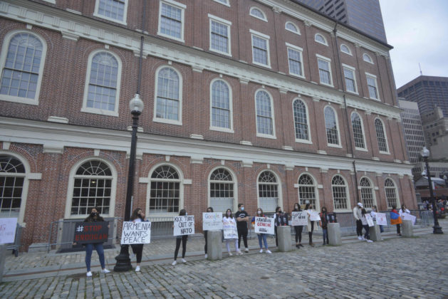 Armenian-Americans rally and protest Azerbaijani and Turkish attacks and aggression on the Republic of Artsakh, Nagorno Karabakh, in a silent action at Faneuil Hall and Quincy Marketplace in Boston. Tourists and locals out for a last warm day of the Autumn despite the Covid-19 Pandemic eventually interacted with the demonstrators after reading the informative signs about the crisis that started with the September 27, attack on the Republic of Artsakh by Azeri forces who want to take back the land by military action.