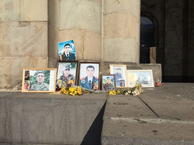 1. A makeshift diorama commemorating those lost in the war set up by protestors. Other demonstrators also held portraits of their lost loved ones.