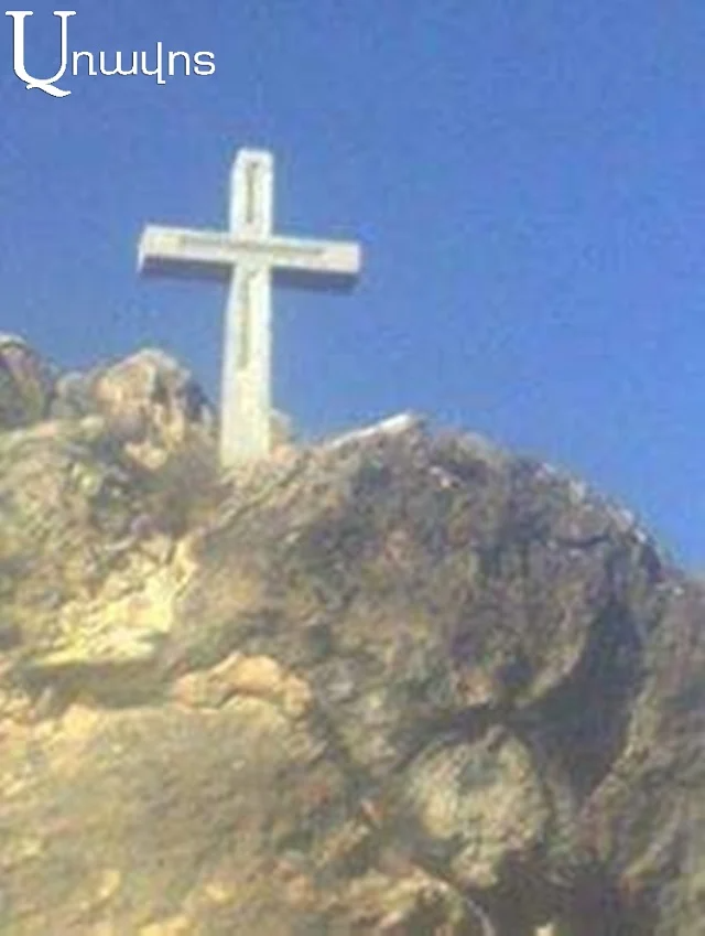 Residents of Karahunj transfer cross placed on hill to the village