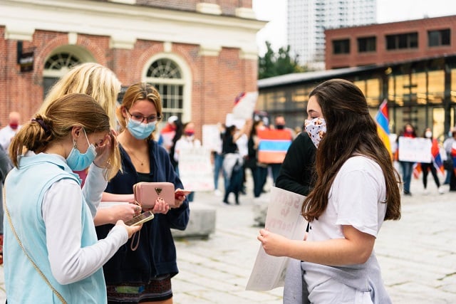 AYF Greater Boston “Nejdeh” Chapter member Nairi Krafian raising awareness, sharing QR code with passers-by at Faneuil Hall silent protest, October 24, 2020 (Photo: Knar Bedian)