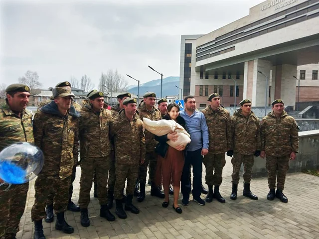 Hero Ashot Mikayelyan’s newborn son escorted home by father’s friends in combat singing Armenian national anthem: ‘I must be strong so that I can be both a father and a mother’