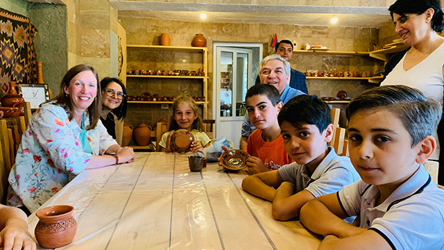 Ambassador Tracy and Mr. Allelo purchased the clay souvenirs made by the children