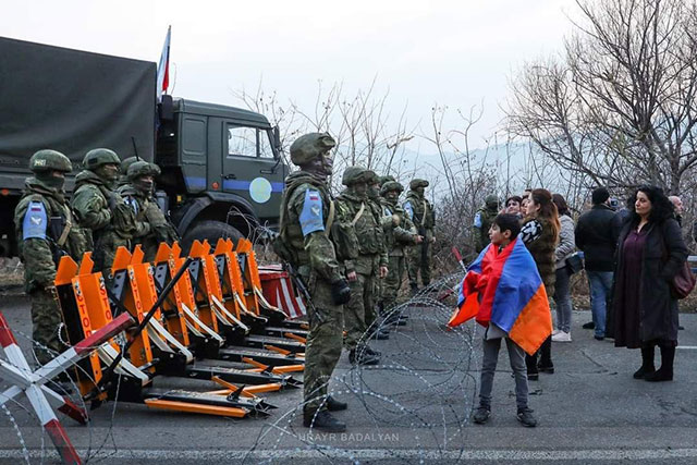 A group of citizens march towards Russian peacekeeping checkpoint to demand the withdrawal of Azerbaijanis from Lachin corridor