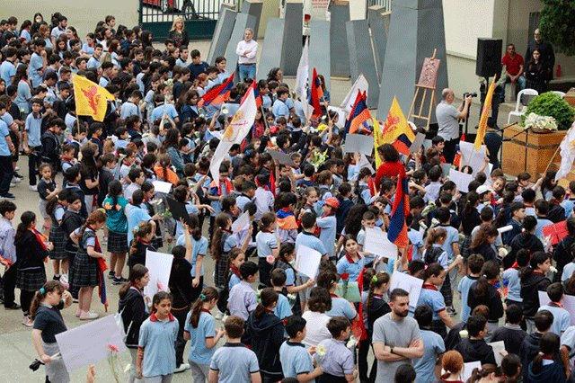 The students were baring the flags of Armenia, Artsakh and Cilicia and holding banners commemorating the victims of the Genocide